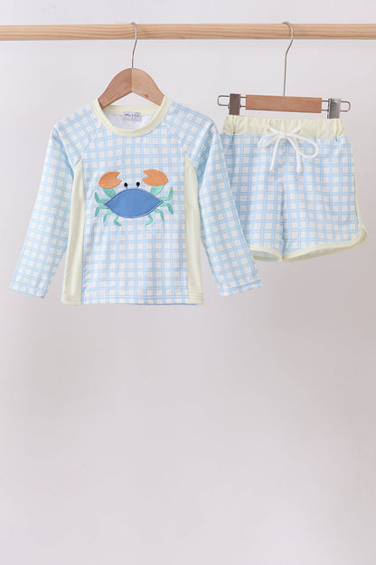 Children's clothing. Blue Crab Appliqué Plaid 2-Piece Boys Rashguard Set. A playful blue crab appliqué on a classic plaid pattern, a coordinated rashguard top and bottoms, and UPF 50+ sun protection make this set the perfect combination of preppy personality and summer-ready performance.