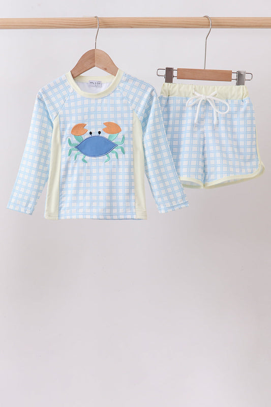 Children's clothing. Blue Crab Appliqué Plaid 2-Piece Boys Rashguard Set. A playful blue crab appliqué on a classic plaid pattern, a coordinated rashguard top and bottoms, and UPF 50+ sun protection make this set the perfect combination of preppy personality and summer-ready performance.