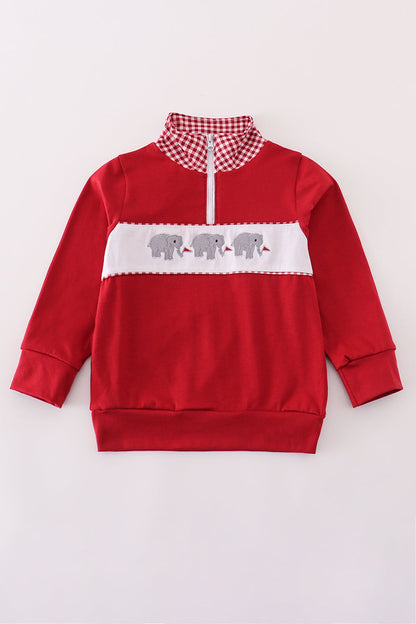 Red sweatshirt with white accents and elephant design on a light gray background