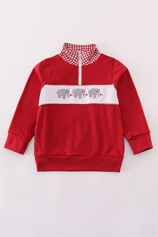 Red sweatshirt with white accents and elephant design on a light gray background