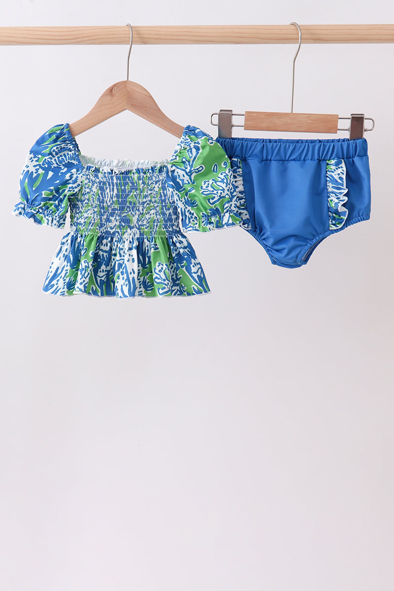 Children's clothing boutique Ocean Garden Print Ruffle 2-Piece Girls Swimsuit. Vibrant blue and green ocean-inspired graphics, playful ruffle detailing, and UPF 50+ sun protection make this coordinated set the perfect combination of cute and functional for every beach day, pool party, and summer adventure.