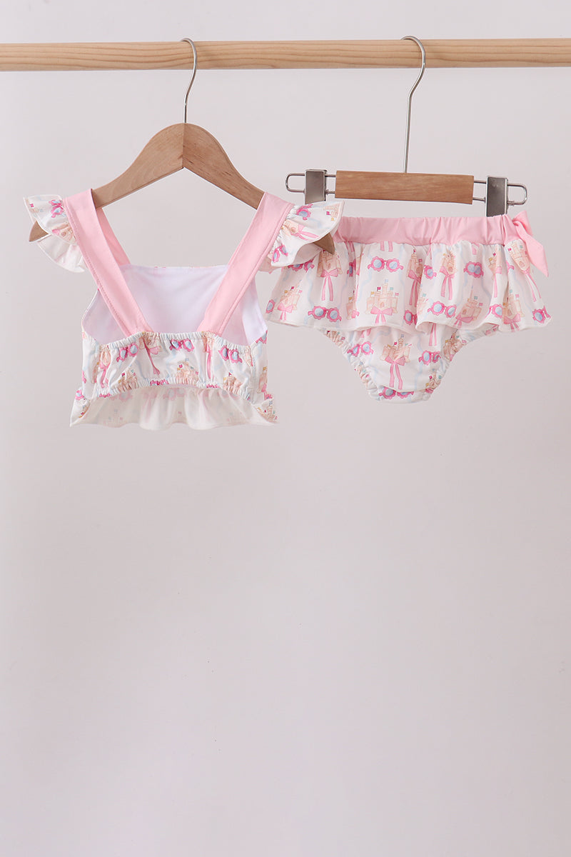 Floral baby outfit with ruffled details on a hanger against a light background