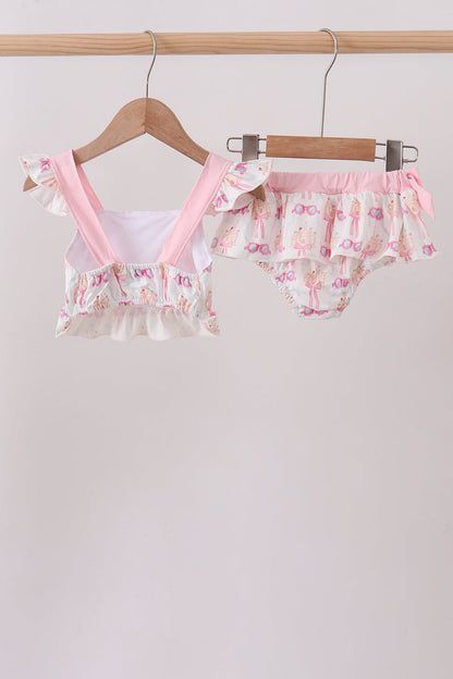Floral baby outfit with ruffled details on a hanger against a light background