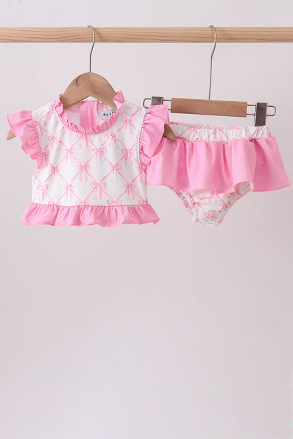 Pink Bow Ruffle 2-Piece Girls Swimsuit. A playful pink bow detail, delicate ruffled accents, and a coordinated bikini top and bottom make this set as charming as it is fun for beach days, pool parties, and every sunny summer adventure.

Pink bow embellishment — a sweet, eye-catching detail that adds instant charm
Ruffle accents — feminine flair that makes this set stand out from the crowd
Coordinated 2-piece set — matching bikini top and bottom for an effortlessly put-together l