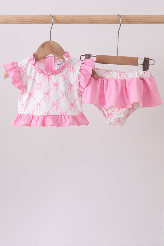 Pink Bow Ruffle 2-Piece Girls Swimsuit. A playful pink bow detail, delicate ruffled accents, and a coordinated bikini top and bottom make this set as charming as it is fun for beach days, pool parties, and every sunny summer adventure.

Pink bow embellishment — a sweet, eye-catching detail that adds instant charm
Ruffle accents — feminine flair that makes this set stand out from the crowd
Coordinated 2-piece set — matching bikini top and bottom for an effortlessly put-together l