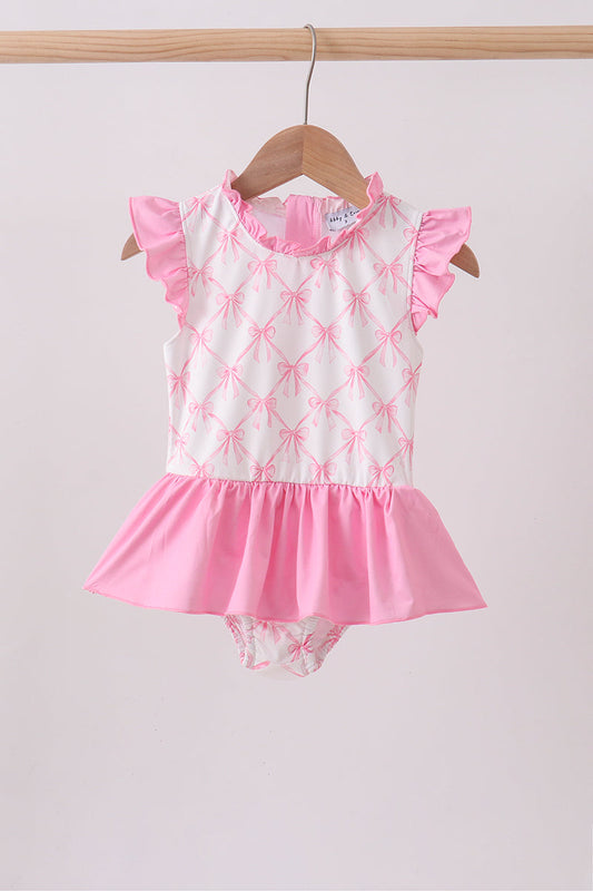 Pink Bow Ruffle One-Piece Girls Swimsuit. Delicate ruffles at the neckline and sides, a sweet bow detail, and a classic cut that provides comfortable coverage make this the perfect swimsuit for beach days, pool parties, and every picture-perfect summer moment.mSweet bow detail — a charming feminine accent that makes this suit extra special
Ruffle trim. Sizes 12M–12 Years — perfect from baby to big girl
