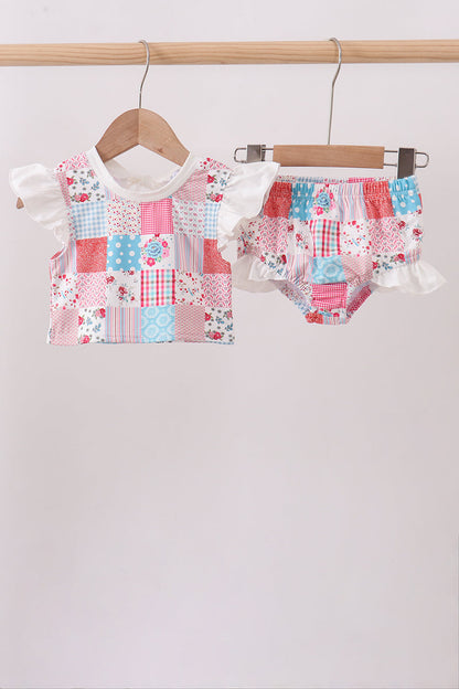 Children's boutique Pink Floral Patchwork Ruffle 2-Piece Girls Swimsuit. A vibrant mix of coordinating floral prints in a fun patchwork design, playful ruffle detailing, and a coordinated top and bottom make this set as stylish as it is sweet — perfect for beach days, pool parties, and vacation getaways.