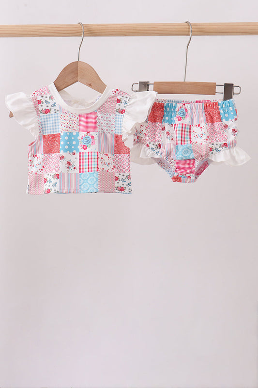 Children's boutique Pink Floral Patchwork Ruffle 2-Piece Girls Swimsuit. A vibrant mix of coordinating floral prints in a fun patchwork design, playful ruffle detailing, and a coordinated top and bottom make this set as stylish as it is sweet — perfect for beach days, pool parties, and vacation getaways.
