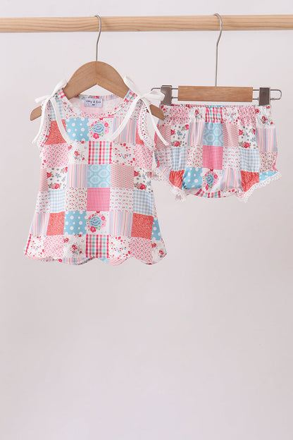 Baby girl boutique outfit. Pink Floral Patchwork Scalloped Bloomer Set. A charming mix of coordinating floral prints in soft pink tones, delicate scalloped edges, and gentle stretch fabric make this set as beautiful as it is comfortable — perfect for playdates, family photos, and every precious everyday moment.