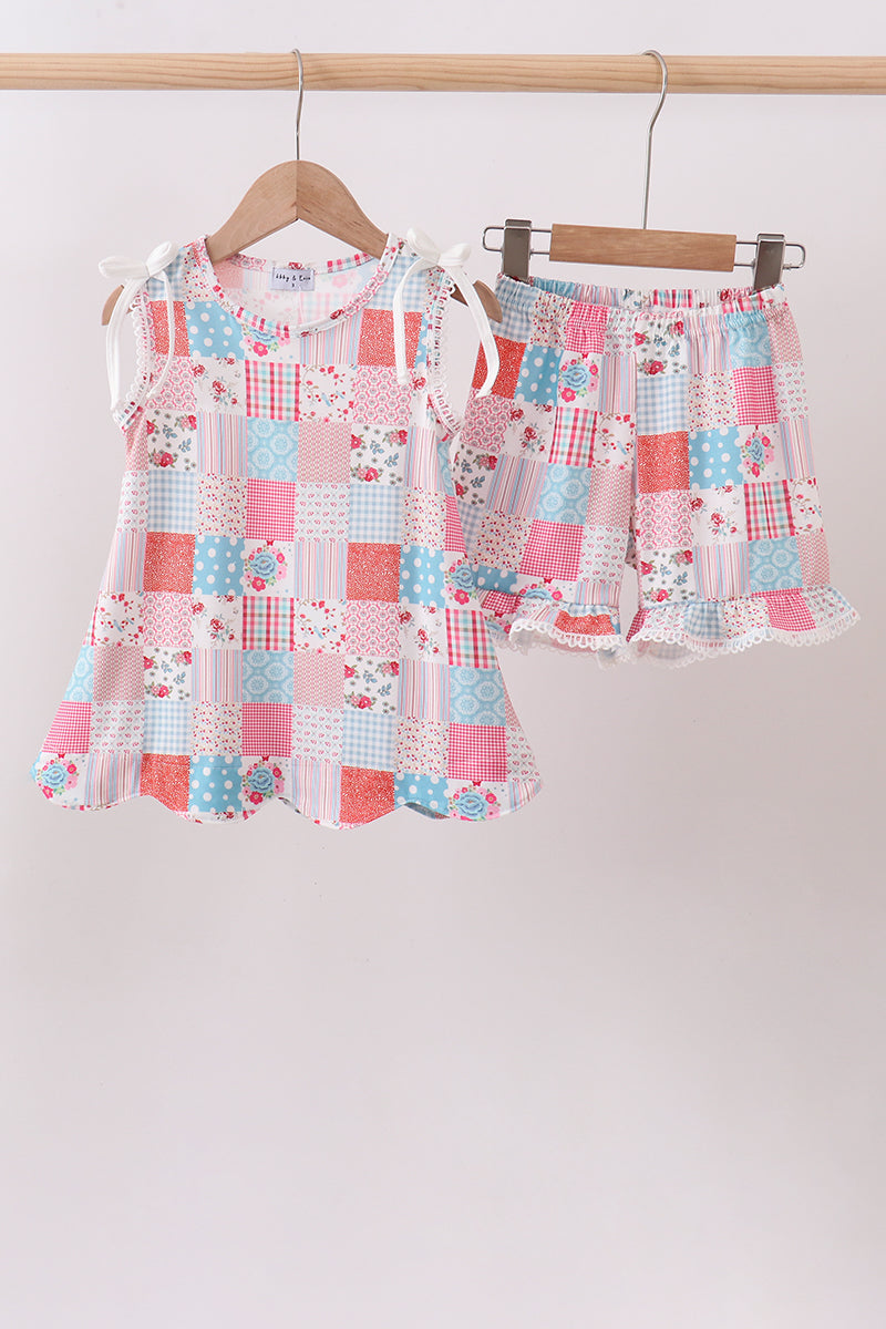Children's boutique Pink Floral Patchwork Scalloped Ruffle Shorts Set. A beautiful mix of coordinating floral prints in soft pink tones, delicate scalloped ruffle trim, and a comfortable stretch fabric make this set the perfect choice for warm-weather adventures, casual outings, and relaxed weekend style.