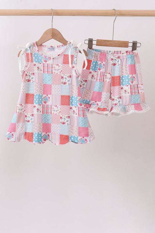 Children's boutique Pink Floral Patchwork Scalloped Ruffle Shorts Set. A beautiful mix of coordinating floral prints in soft pink tones, delicate scalloped ruffle trim, and a comfortable stretch fabric make this set the perfect choice for warm-weather adventures, casual outings, and relaxed weekend style.