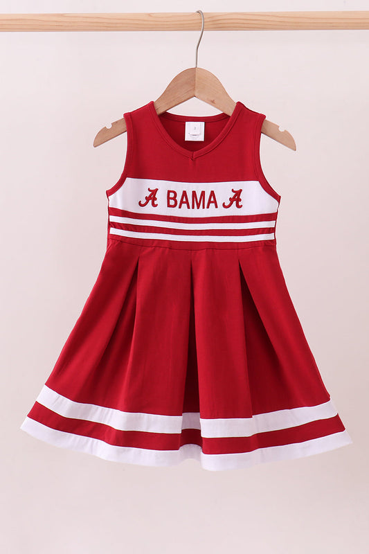 Red dress with 'Alabama' text on a beige background