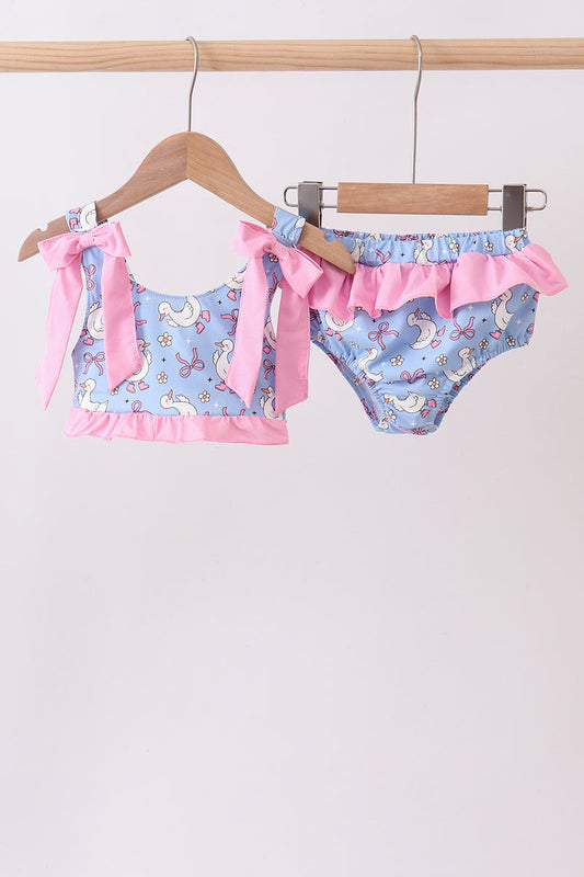 Purple Duck Print Bow Ruffle 2-Piece Girls Swimsuit. A playful purple duck print, sweet bow-adorned ruffles, and a coordinated top and bottom make this set the perfect combination of whimsical and wonderful for every summer splash.