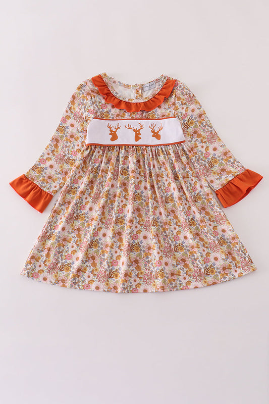 Floral dress with orange accents on a white background