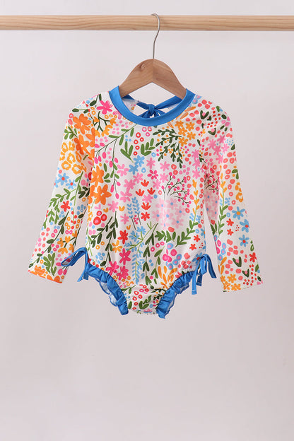 Children's clothing boutique. Summer Floral Print Ruffle Rashguard. A vibrant floral design, delicate ruffle detailing, and UPF 50+ sun protection make this rashguard the perfect combination of fashion and function for beach days, pool time, and every water adventure this summer.