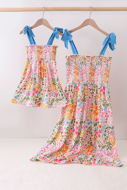 women and children's clothing boutique. Summer Floral Print Smocked Mom and Me Dress Set. Delicate blooms in vibrant colors, a flattering smocked bodice, and lightweight breathable fabric make these coordinating dresses the perfect choice for family photos, summer outings, and every special occasion worth remembering.